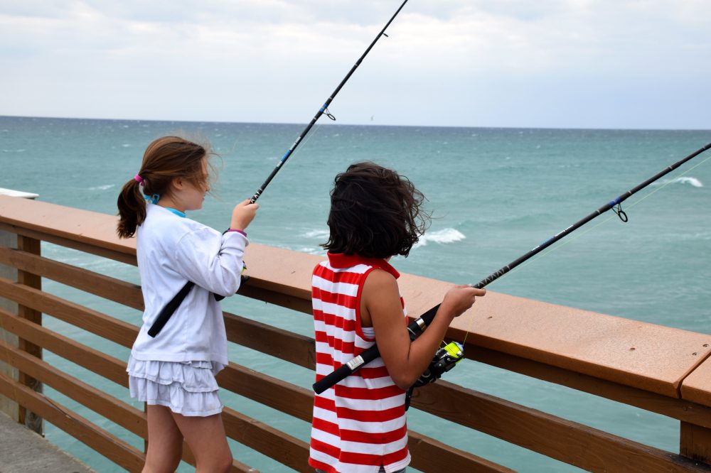 two-anglers-fishing-on-the-juno-beach-pier-during-kids-fishing-program